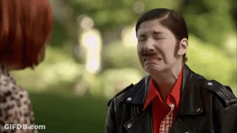 A Woman In A Leather Jacket Is Crying While Talking To Another Woman In A Park . GIF