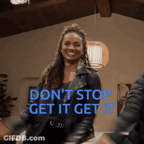 A Woman In A Leather Jacket Is Dancing With The Words " Don 'T Stop Get It Get It " Behind Her GIF