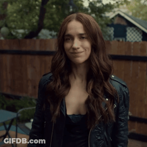 A Woman In A Leather Jacket Is Giving A Thumbs Up Sign GIF