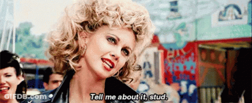 A Woman In A Leather Jacket Is Saying Tell Me About It Stud GIF