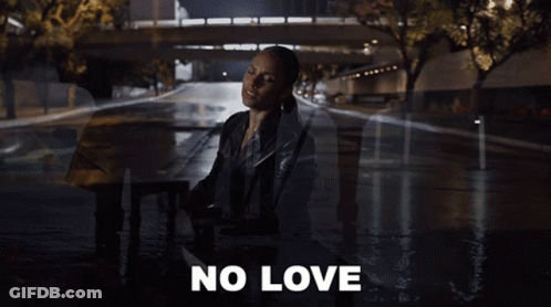 A Woman In A Leather Jacket Is Singing A Song With The Words No Love Behind Her GIF