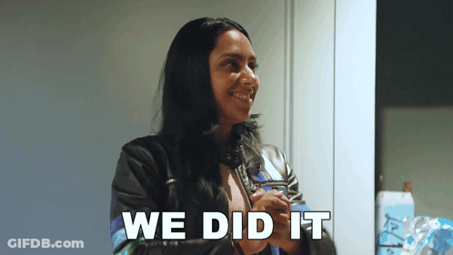 A Woman In A Leather Jacket Is Smiling With The Words We Did It Behind Her GIF