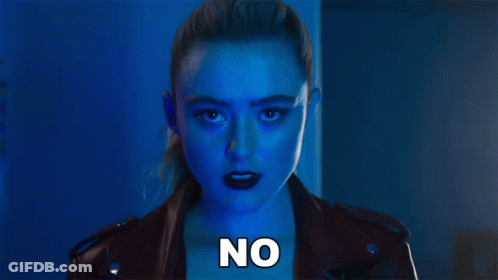 A Woman In A Leather Jacket With The Word No Written On Her Chest GIF