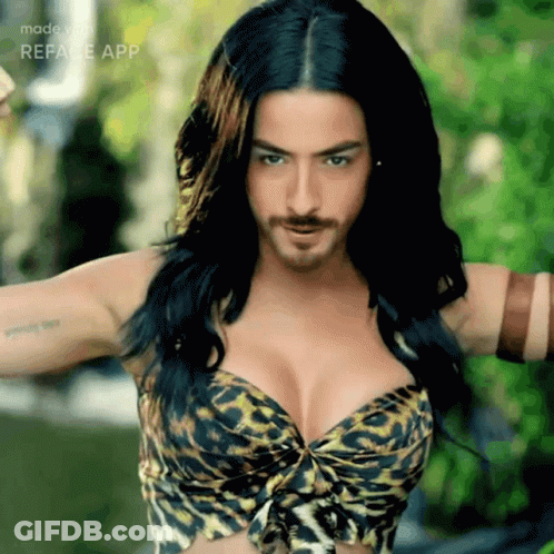 A Woman In A Leopard Print Bra Has A Beard GIF