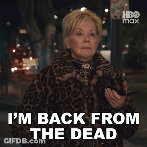 A Woman In A Leopard Print Coat Is Saying " I 'M Back From The Dead " GIF