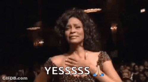 A Woman In A Leopard Print Dress Is Dancing In Front Of A Crowd And Says Yesssss . GIF