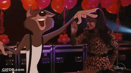 A Woman In A Leopard Print Dress Is Dancing Next To A Cartoon Cat . GIF