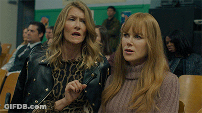 A Woman In A Leopard Print Dress Stands Next To Another Woman In A Pink Sweater GIF