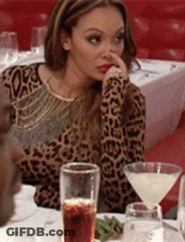 Woman In Leopard Print Shirt At Table With Martini And Soda GIF