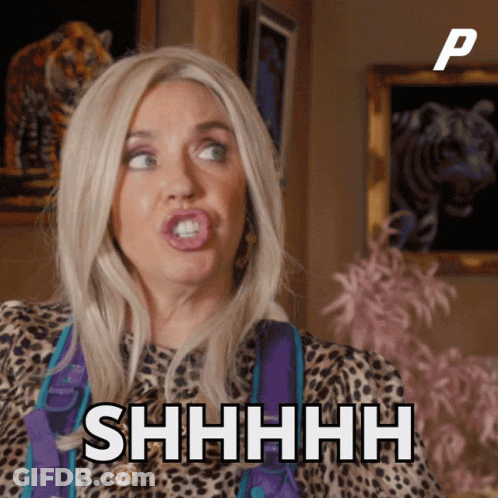 A Woman In A Leopard Print Shirt Says Shhhh In Front Of A Picture Of A Tiger GIF