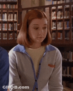 A Woman In A Library With The Words A-Ha Written On Her Face GIF
