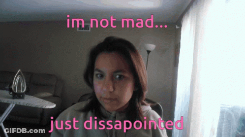 A Woman In A Living Room With The Words Im Not Mad Just Disappointed Above Her GIF