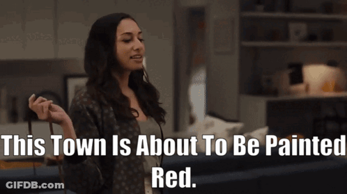 A Woman In A Living Room With The Words " This Town Is About To Be Painted Red " GIF