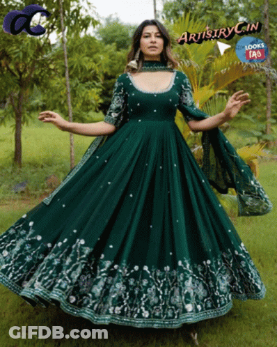 A Woman In A Long Green Dress With Artistry In Written On The Bottom Right GIF