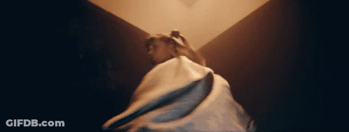 A Woman In A Long White Dress Is Dancing GIF