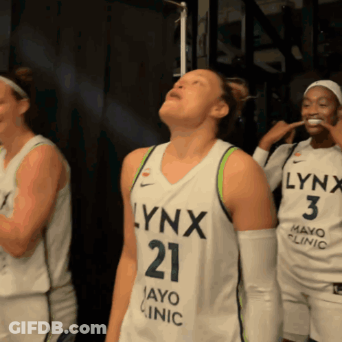 A Woman In A Lynx Jersey Looks Up GIF