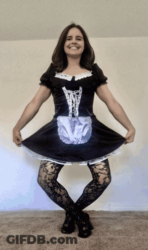 A Woman In A Maid Costume Is Smiling GIF