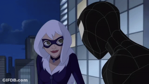 A Woman In A Mask Is Standing Next To A Man In A Suit GIF