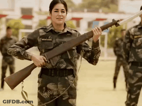 Woman In Military Uniform Holding Gun GIF