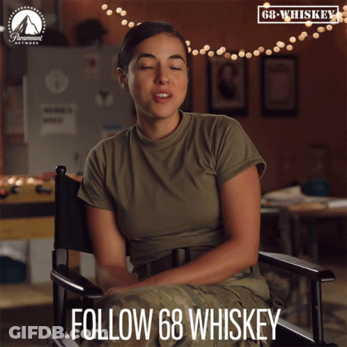 Woman In Military Uniform Sitting In Director's Chair GIF