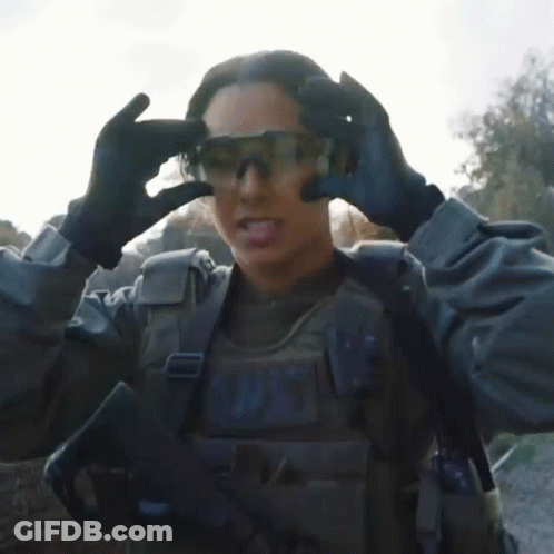 A Woman In A Military Uniform With The Word N.w.t. On Her Chest GIF