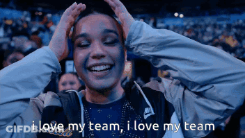 A Woman In A Nike Jacket Holds Her Hands To Her Head And Says I Love My Team GIF