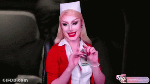 A Woman In A Nurse Costume Is Smiling And Holding A Badge GIF