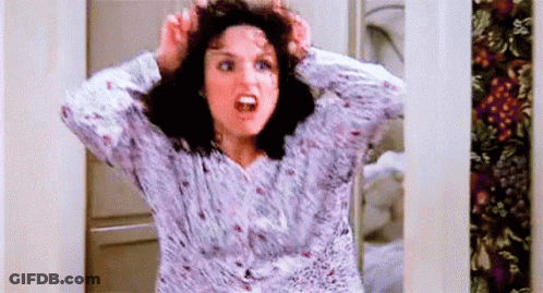 A Woman In A Pajama Shirt Is Holding Her Hair In Her Hands And Screaming . GIF