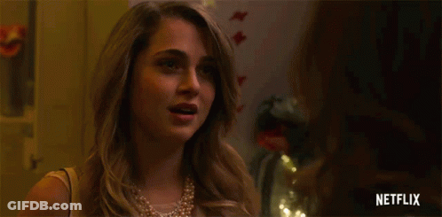 A Woman In A Pearl Necklace Is Pregnant And Says I 'M Pregnant . GIF