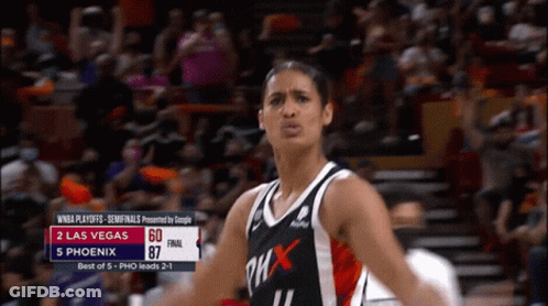A Woman In A Phoenix Jersey Stands In Front Of A Crowd During A Game GIF