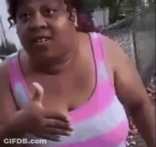 A Woman In A Pink And White Striped Tank Top Is Giving A Thumbs Up GIF