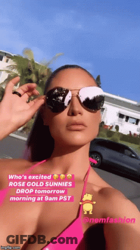 A Woman In A Pink Bikini Is Wearing Sunglasses And A Caption That Says Who 'S Excited GIF