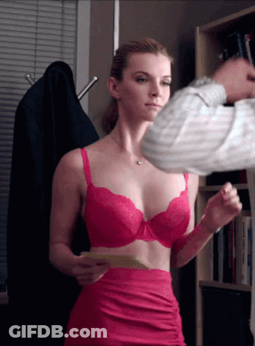A Woman In A Pink Bra And Skirt Is Holding A Piece Of Paper GIF