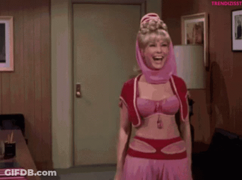 A Woman In A Pink Costume Is Dancing In A Living Room GIF