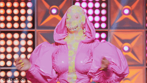 Woman In Pink Costume With Hood And Pearls GIF