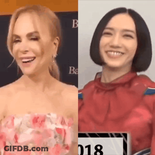 A Woman In A Pink Dress And A Woman In A Red Shirt Are Smiling And Laughing . GIF