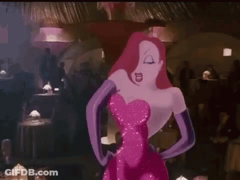A Woman In A Pink Dress And Purple Gloves Is Standing In A Crowded Room . GIF