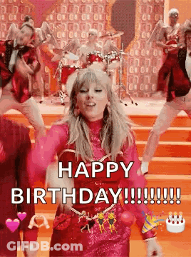A Woman In A Pink Dress Is Dancing On A Stage In Front Of A Group Of People . GIF