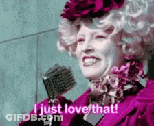 A Woman In A Pink Dress Is Holding A Microphone And Saying `` I Just Love That '' . GIF