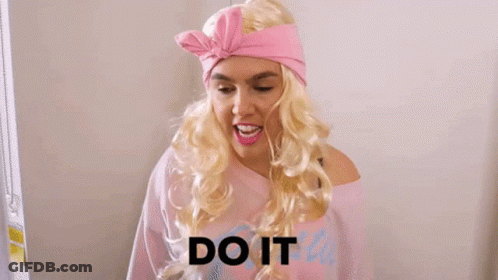 A Woman In A Pink Dress Is Holding A Shrek Toy And The Word Or Else Is On The Bottom GIF
