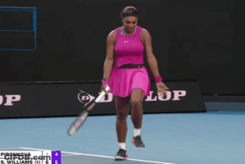 A Woman In A Pink Dress Is Holding A Tennis Racquet In Front Of A Dunlop Banner GIF