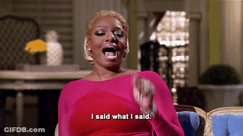 A Woman In A Pink Dress Is Sitting In A Chair And Says I Said What I Said GIF