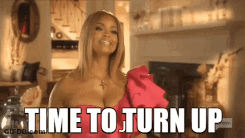 A Woman In A Pink Dress Is Smiling And Says Time To Turn Up GIF