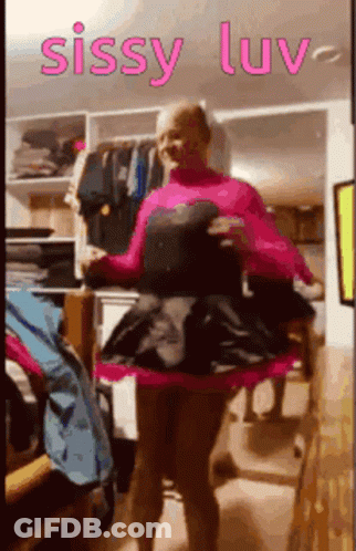 A Woman In A Pink Dress Is Standing In A Closet With The Words Sissy Luv On The Bottom GIF