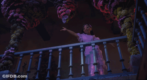 A Woman In A Pink Dress Is Swinging On A Railing GIF