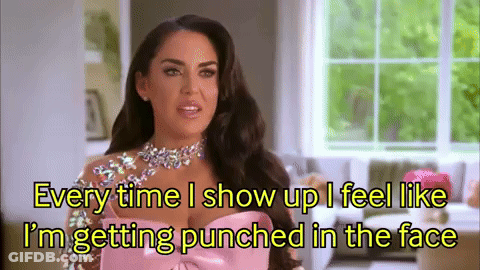 A Woman In A Pink Dress Is Talking About Getting Punched In The Face GIF