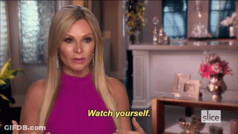 A Woman In A Pink Dress Is Talking To Someone And Says Watch Yourself . GIF