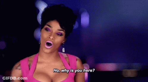 A Woman In A Pink Dress Is Talking To Someone . GIF