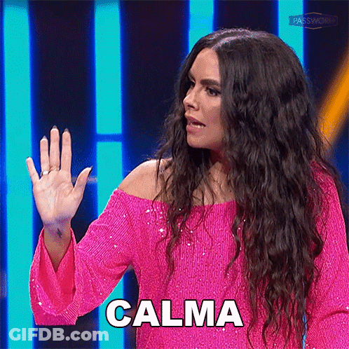 A Woman In A Pink Dress Says Calma With Her Hand Up GIF