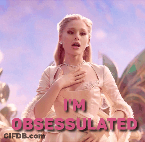 A Woman In A Pink Dress With The Words " I 'M Obsessed " Above Her GIF